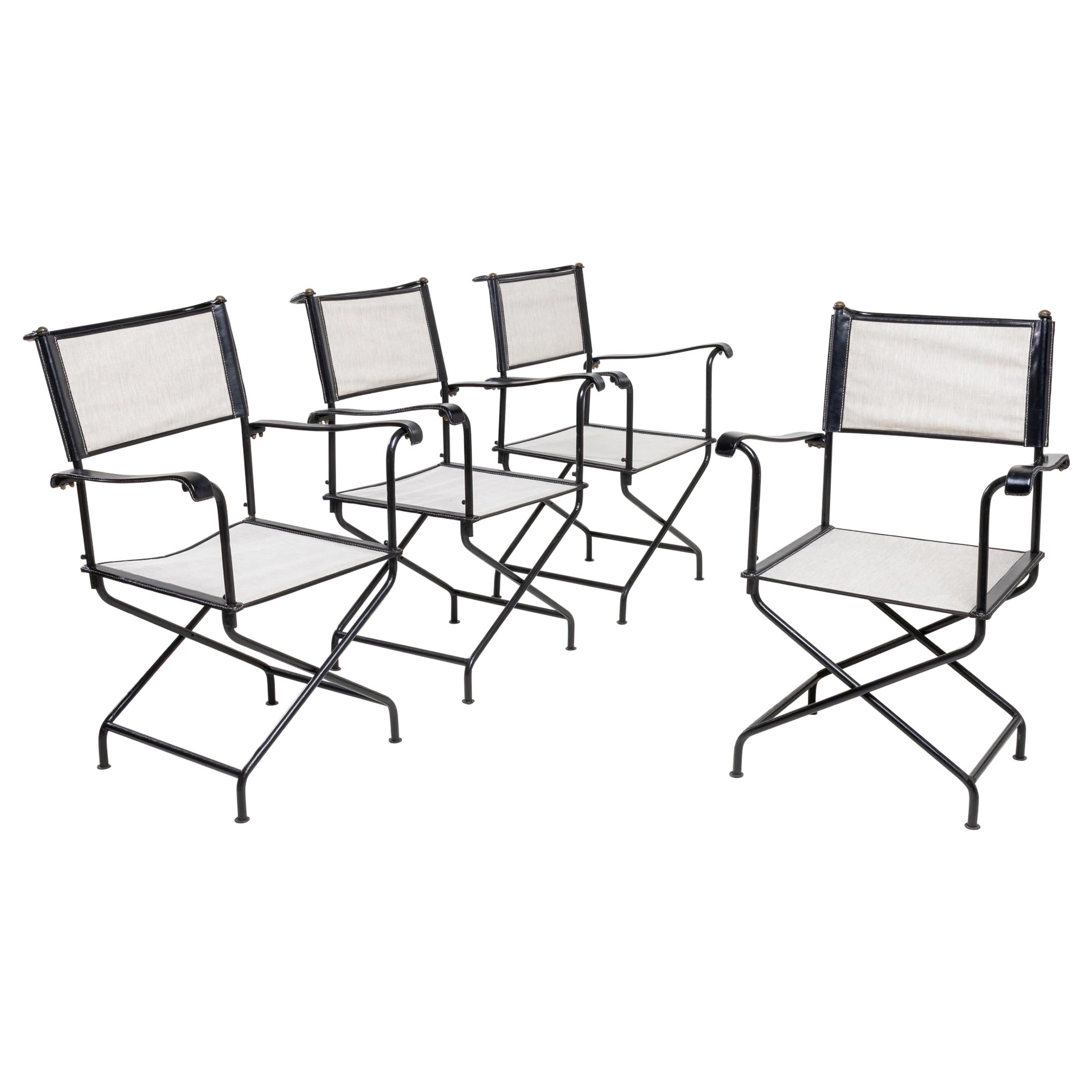 Set of four “Metteur en scène” (director’s) armchairs by Jacques Adnet  For Sale