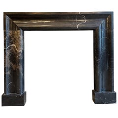 A Large Black Marble Bolection Fireplace Mantle 