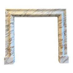 An Arabescato Marble Bolection Fireplace Mantle 