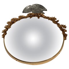 1960's convex mirror with bronze ornament and glass eagle top by Maison Baguès