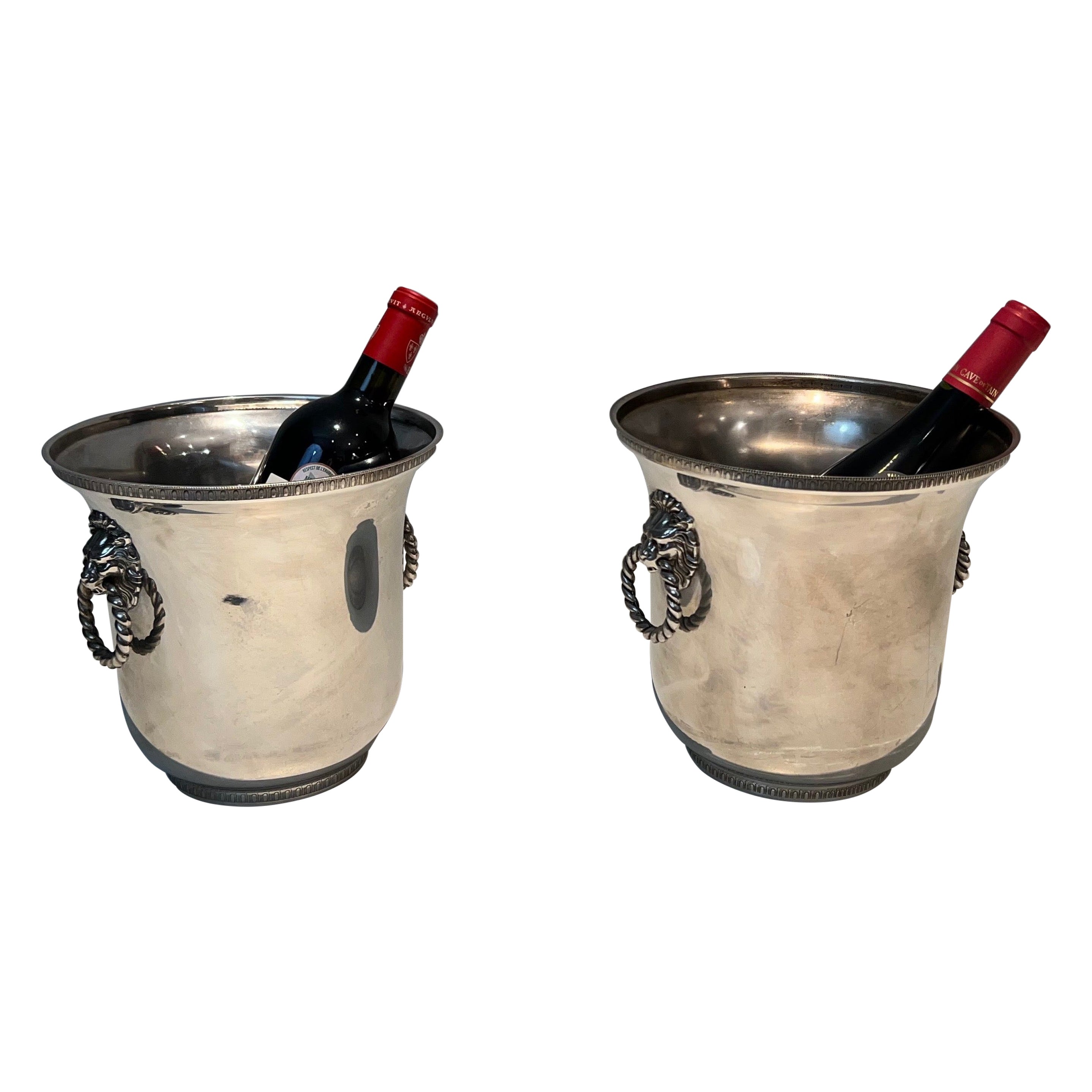 Pair of silver plated champagne buckets ornated on the handles with lion faces.  For Sale
