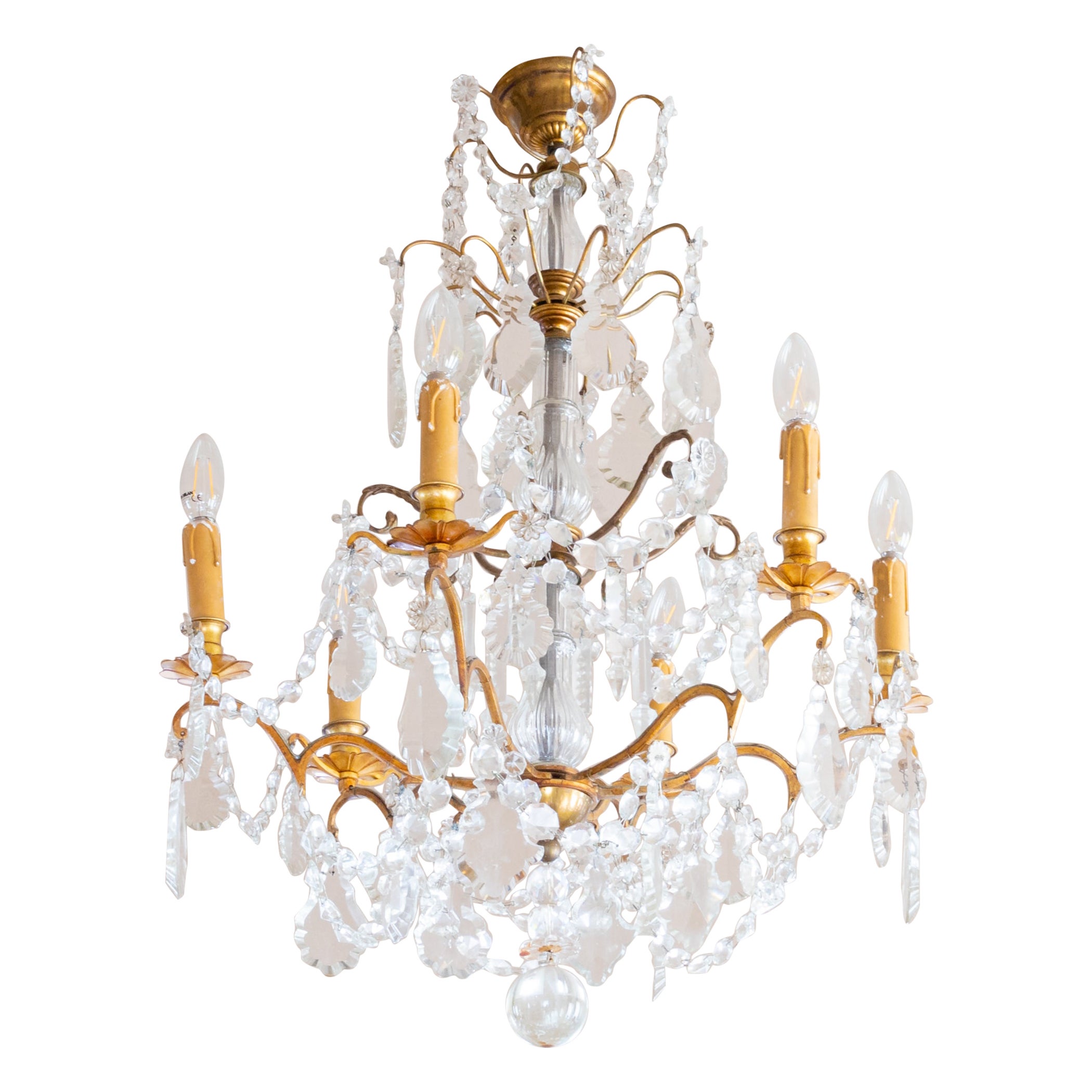 A french Louis XV-Style bronze and crystal chandelier with various crystal and glass pendants and finials, six candlestick holders fully rewired and six light sockets.

The chandelier is currently wired for both European Union and US standards LED