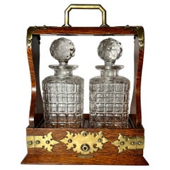 Antique English Golden Oak Two Bottle Tantalus, Circa 1890.