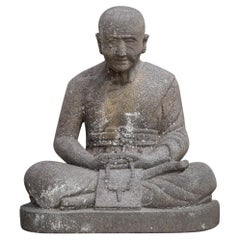 Middle 20th century old lavastone Monk statue in Dhyana Mudra from Indonesia