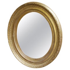 Grand miroir ovale antique doré
