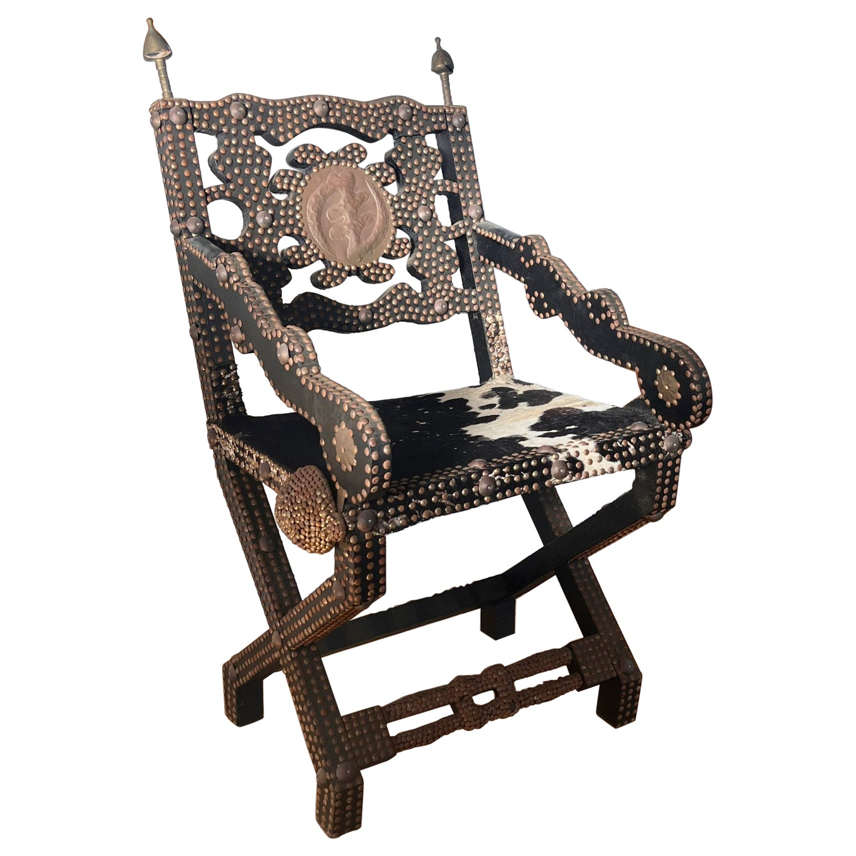 Ghanaian wood, iron, and cowhide chair, early 20th century For Sale