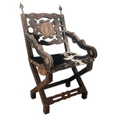 Used Ghanaian wood, iron, and cowhide chair, early 20th century