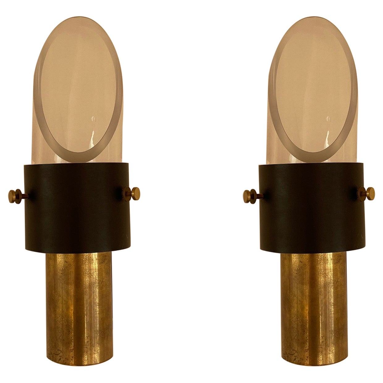 These beautiful wall lights provide slight directional lighting due to the slanted glass shade attached. Beautiful patina evident on the solid brass hardware. An incredibly striking lighting solution.