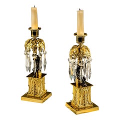 Un'insolita coppia di candelabri militari in bronzo e dorato