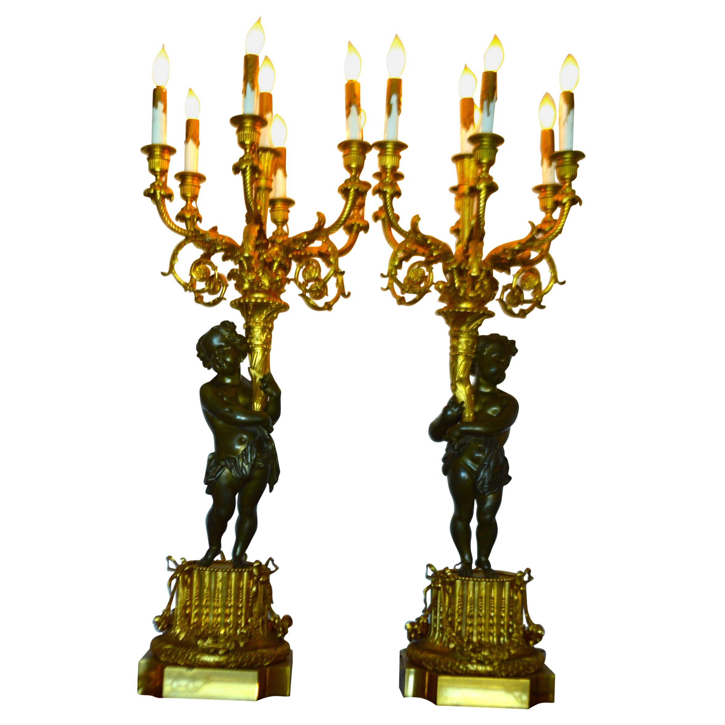 True Pair of electrified gilded bronze candelabras, 7 lights, male, female putti For Sale