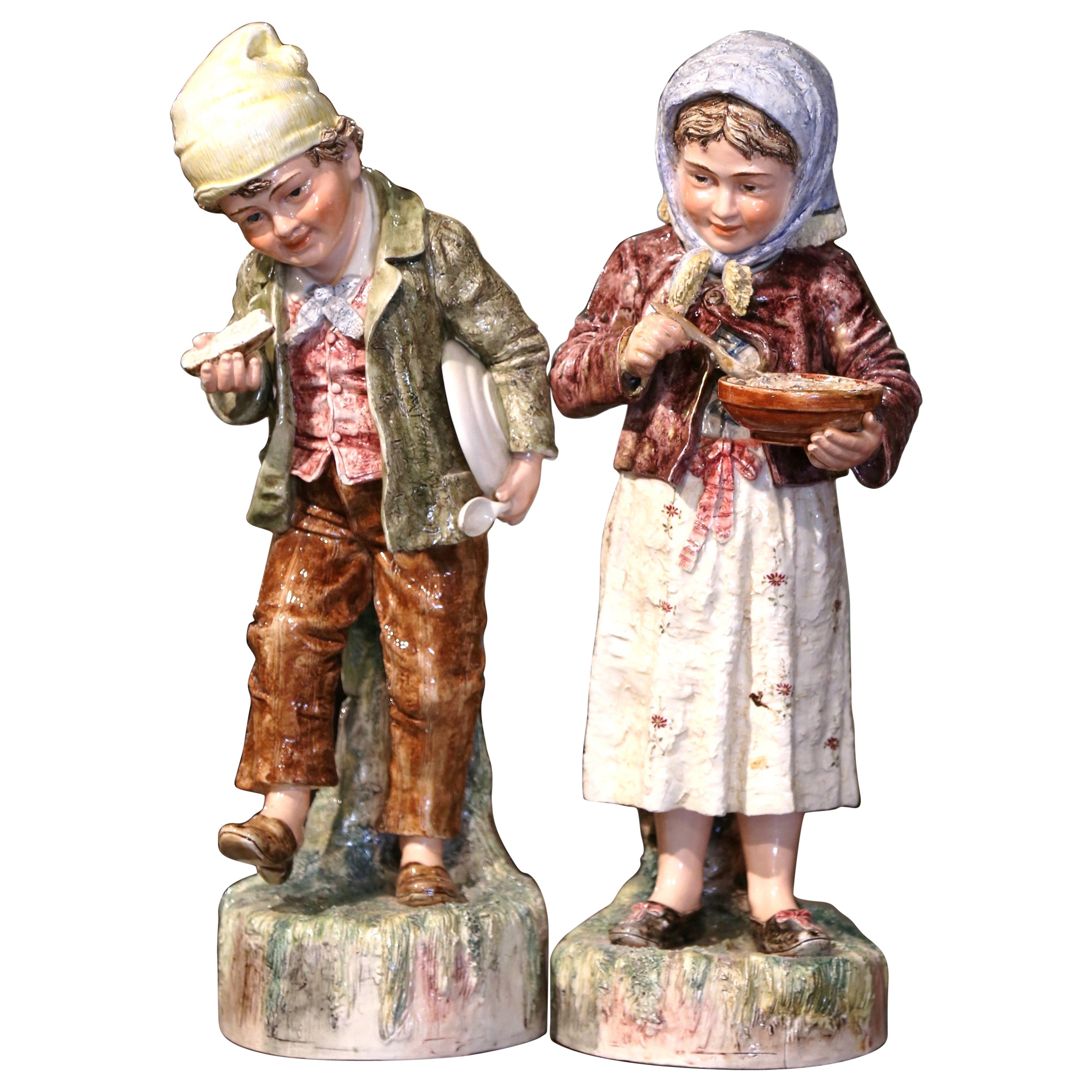 Pair of Early 20th Century French Painted Porcelain Barbotine Children Figurines