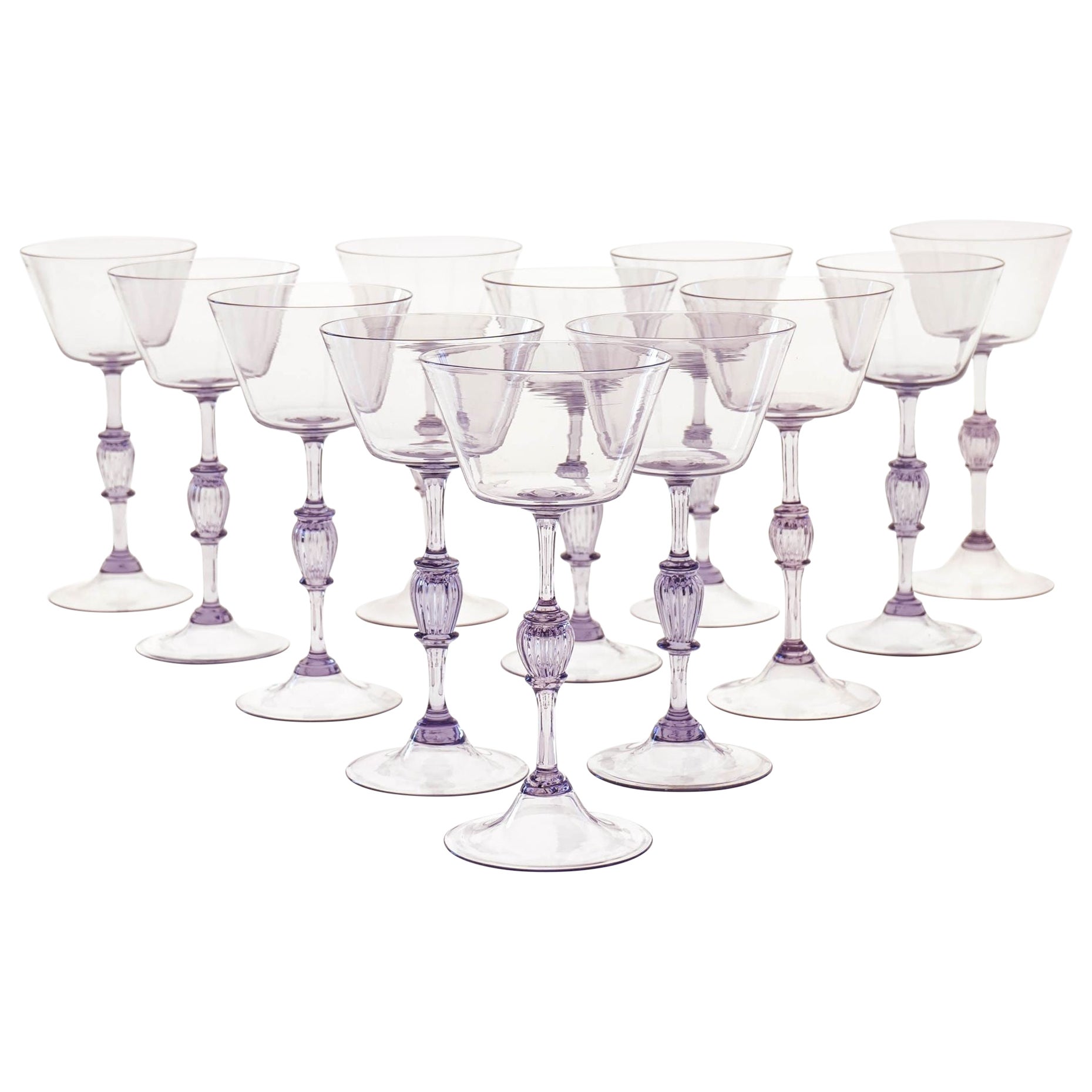 Introducing an Unique and Rare Set of 12 Cyclamen Glass Flutes.
Made in Murano on the 50ties by Cenedese. Almost impossible to find a full 12 pieces set.
This full set of 12 cyclamen glass flutes is a must-have for any collector of vintage glass or