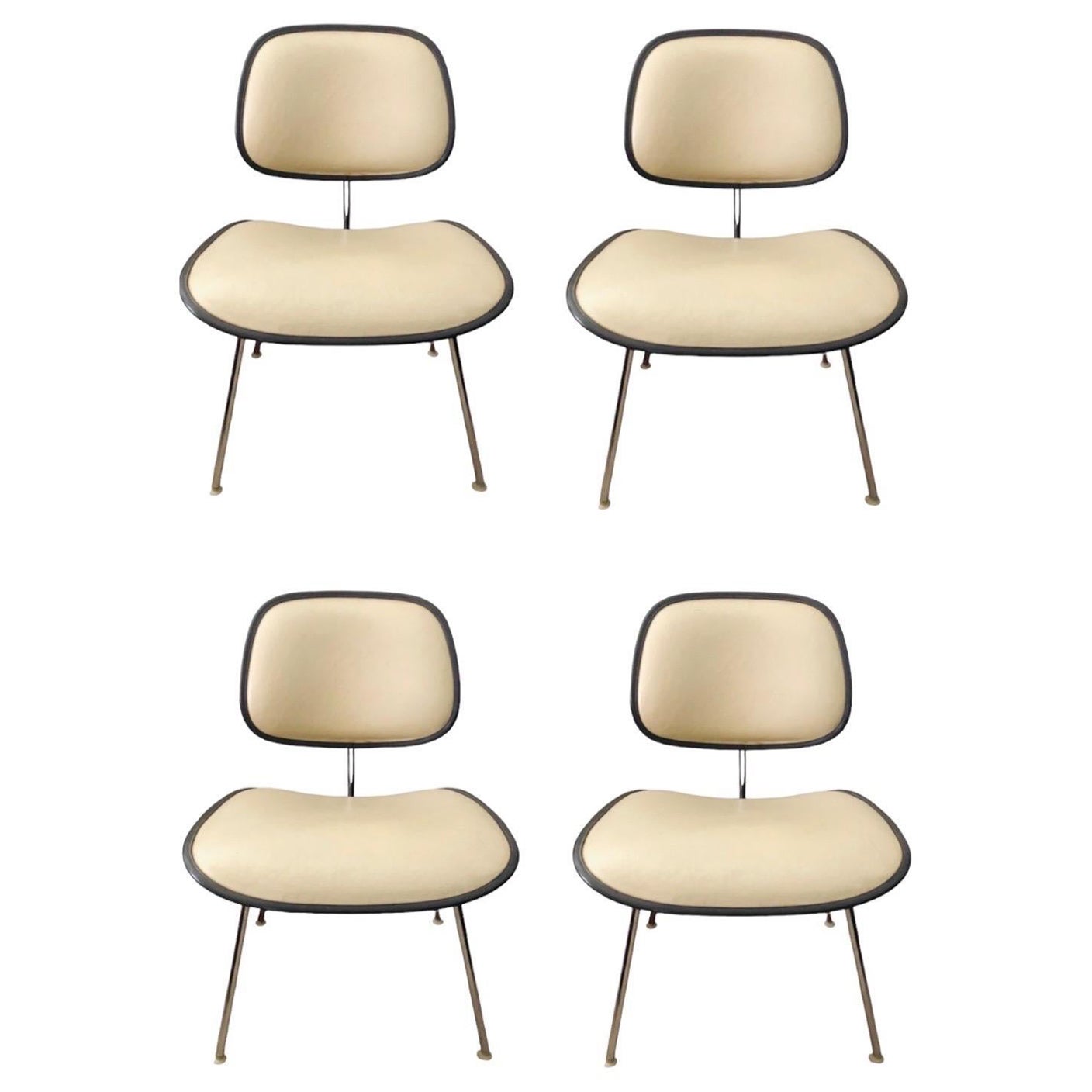 This is a pair of DCMU chairs, designed in 1970 by Charles and Ray Eames for Herman Miller. They were a newer, upholstered take on the classic bent wood DCM chair.

The seat and back are molded plastic, and these are currently upholstered in their