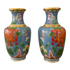 Paire de vases vintage avec motifs floraux et oiseaux et couleurs vives.