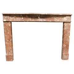 Fireplace mantel in "France Red" speckled marble with carved flowers, France