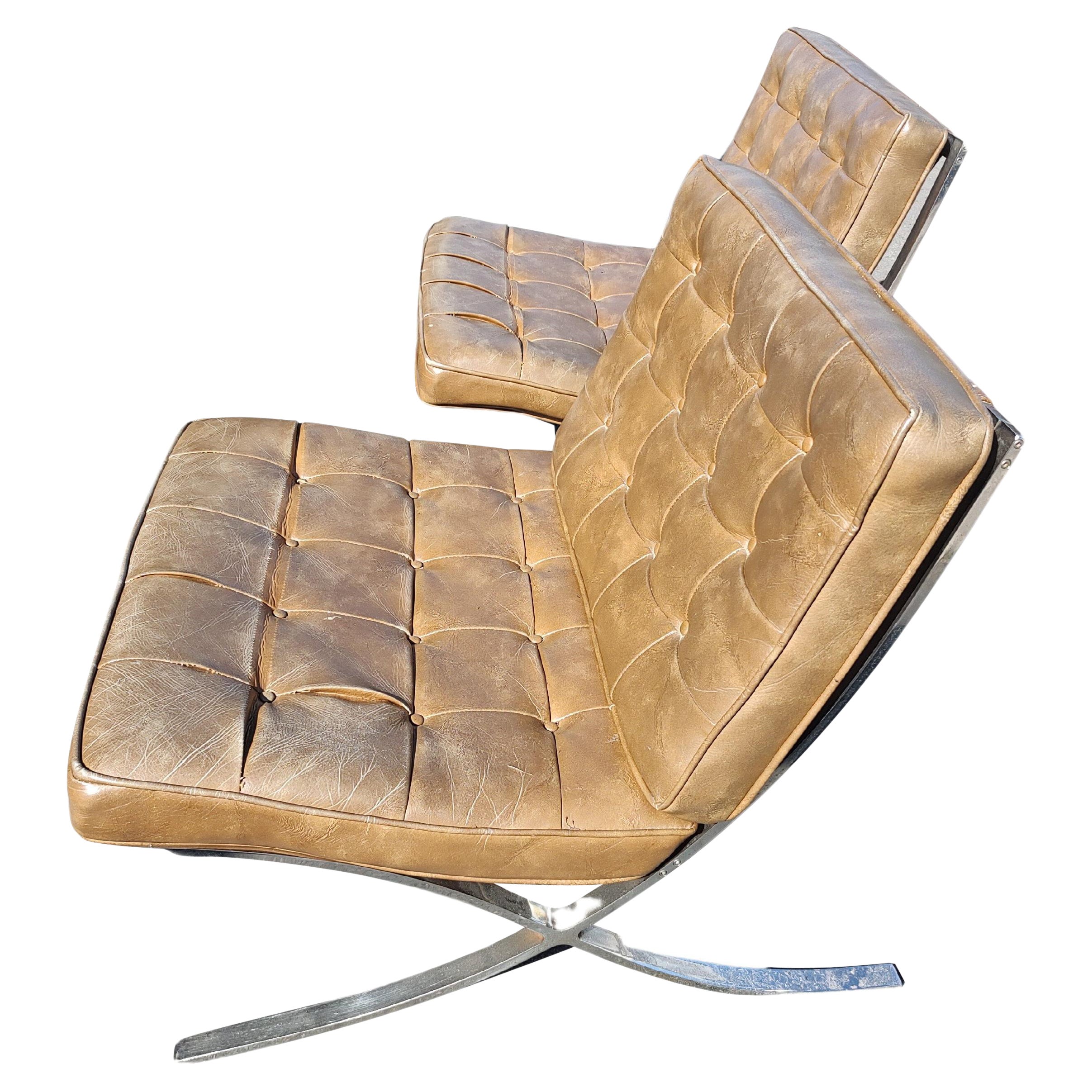 Pair of High Quality Barcelona Lounge Chairs with Brown Naughahyde Vinyl Seats