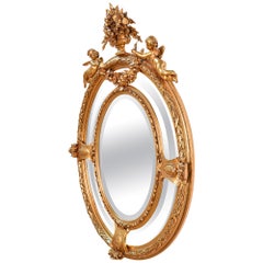 Miroir baroque de la fin du XIXe siècle avec des anges et des éléments floraux sur un cadre en bois