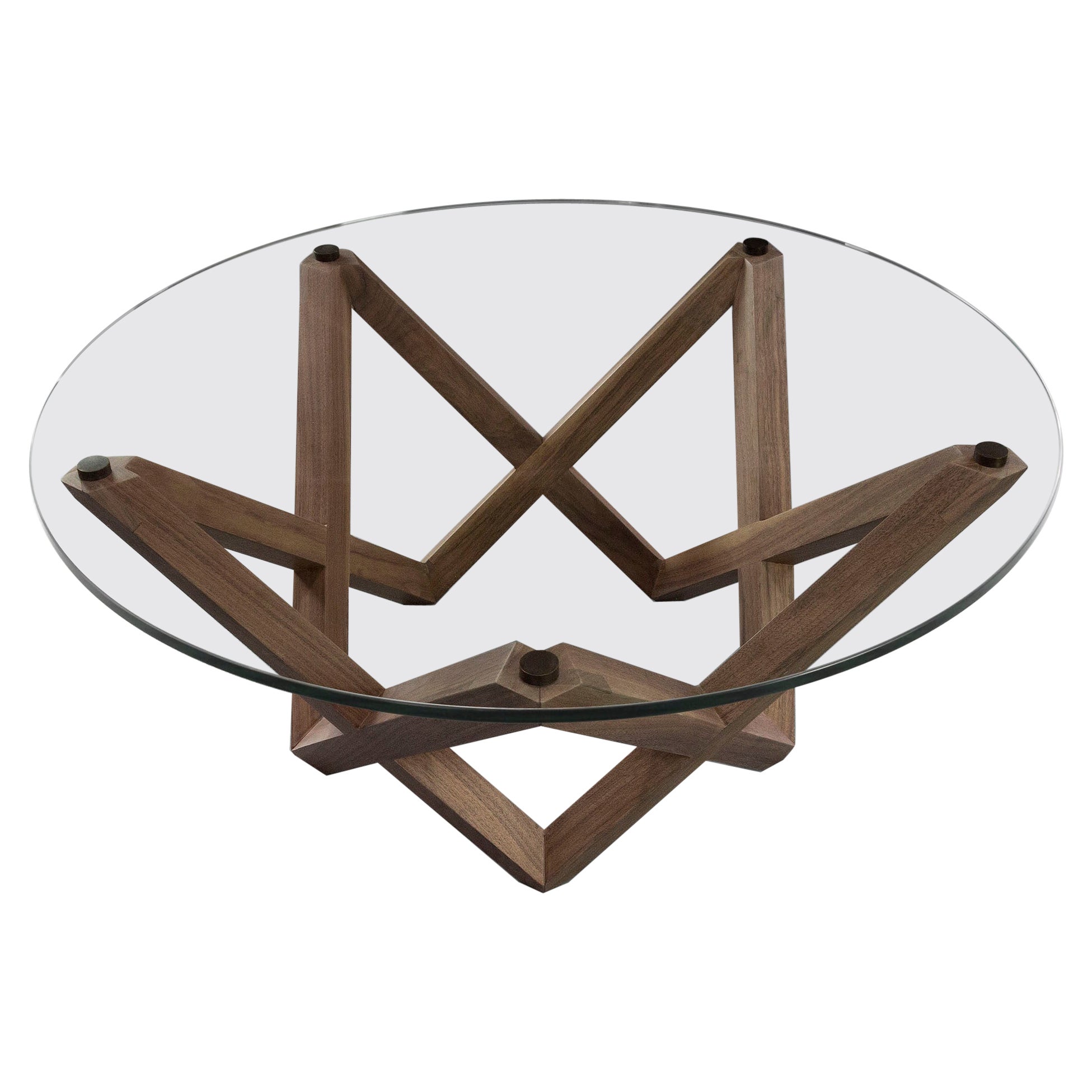 COFFEE TABLE with a black walnut star shaped base and round glass top For Sale