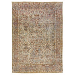 Tapis persan ancien Kerman fait à la main avec un motif floral multicolore