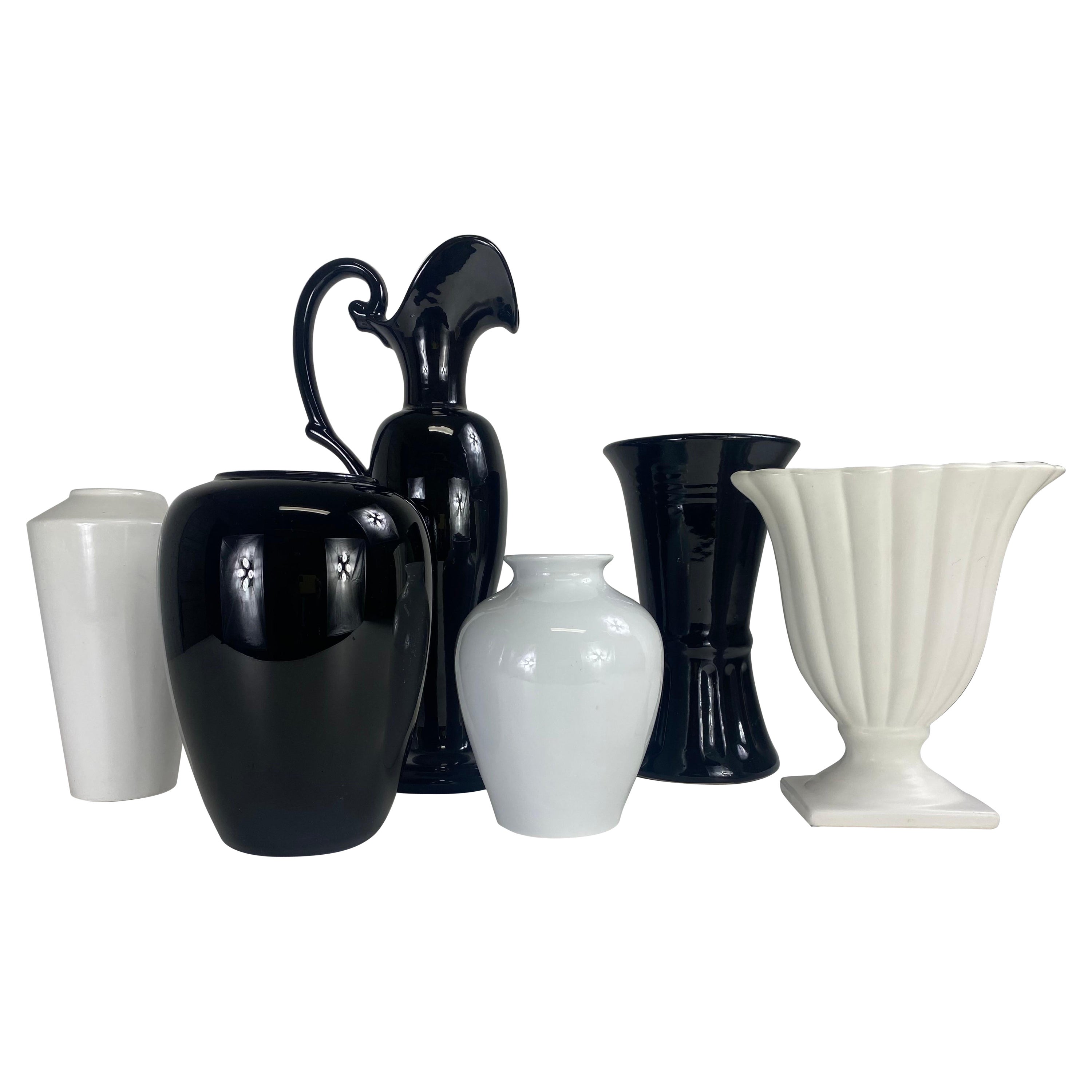 Mid century complementary grouping of black and white pottery vases. For Sale