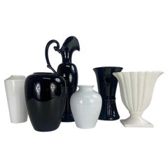 Mid century complementary grouping of black and white pottery vases.