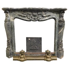 Vintage fireplace mantle in "Verde Alpi" marble, richly carved, Italy