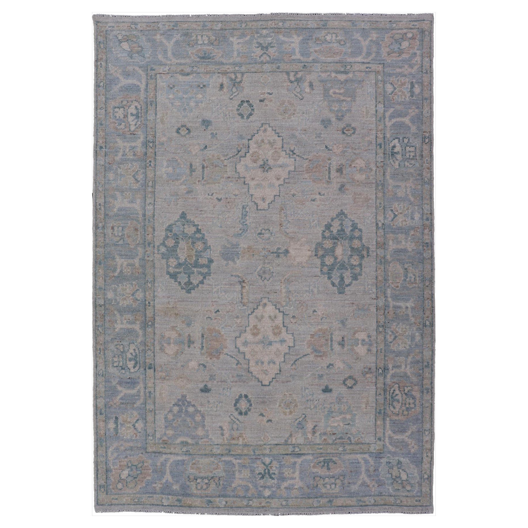Hand-Knotted Oushak with a Light Blue-Gray Background and Tribal Motifs For Sale