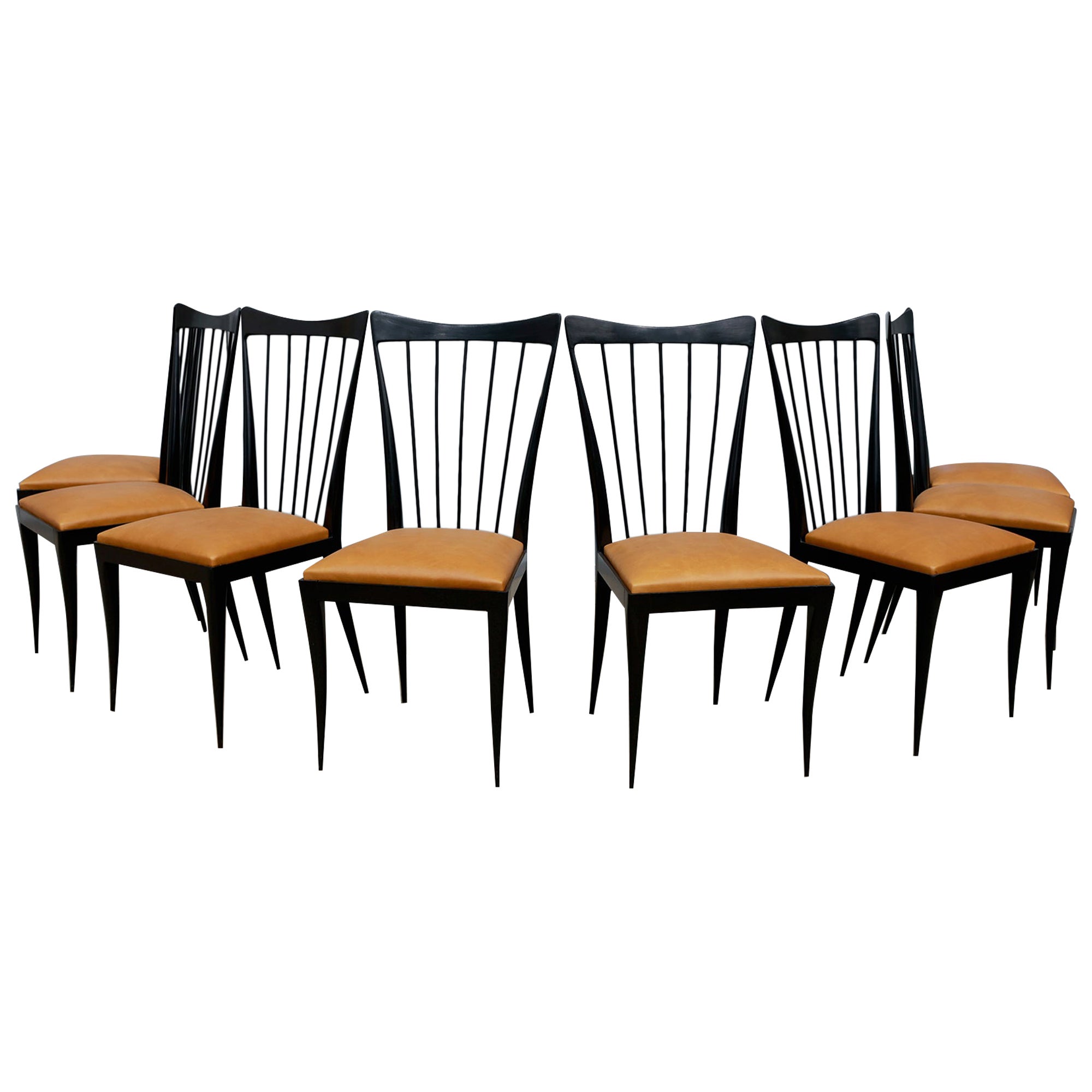 Available today, this set is nothing less than spectacular!

This set of eight dining chairs was designed by Giuseppe Scapinelli in the 1950s. The structure of the chairs is in hardwood with an ebony finish. The sculpted back and legs are typical of