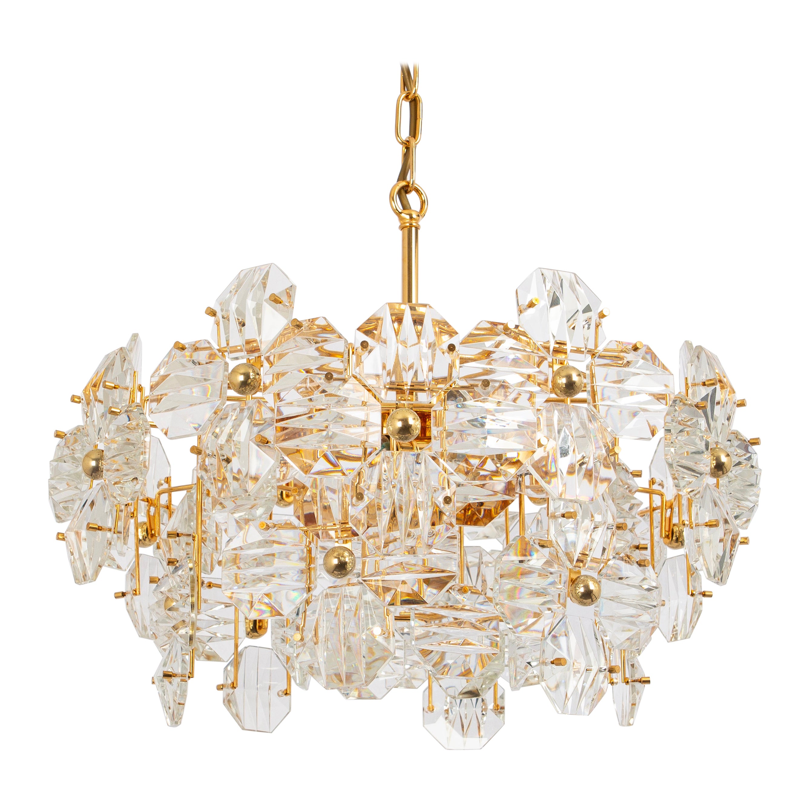 A stunning chandelier by Kinkeldey, Germany, manufactured in circa 1970-1979. A handmade and high-quality piece. The fixture is made of brass with lots of facetted crystal glass elements.

Sockets: 6 x E14 candelabra and one x E27 standard