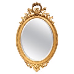 19th Century French Louis XVI Carved Giltwood Oval Beveled Glass Wall Mirror