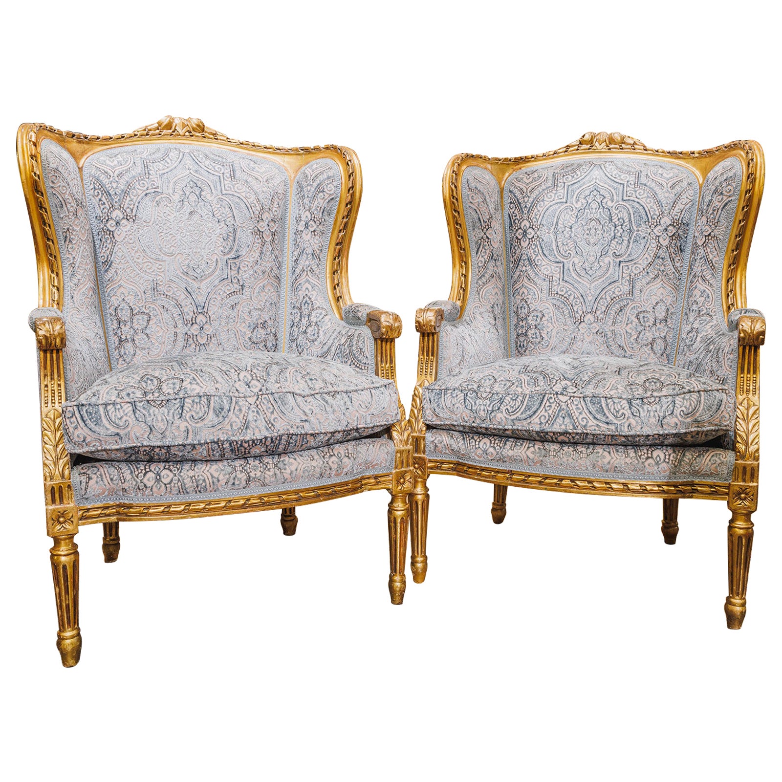 A fine pair of 19th century Louis XVI water gilt and carved wingchairs  For Sale