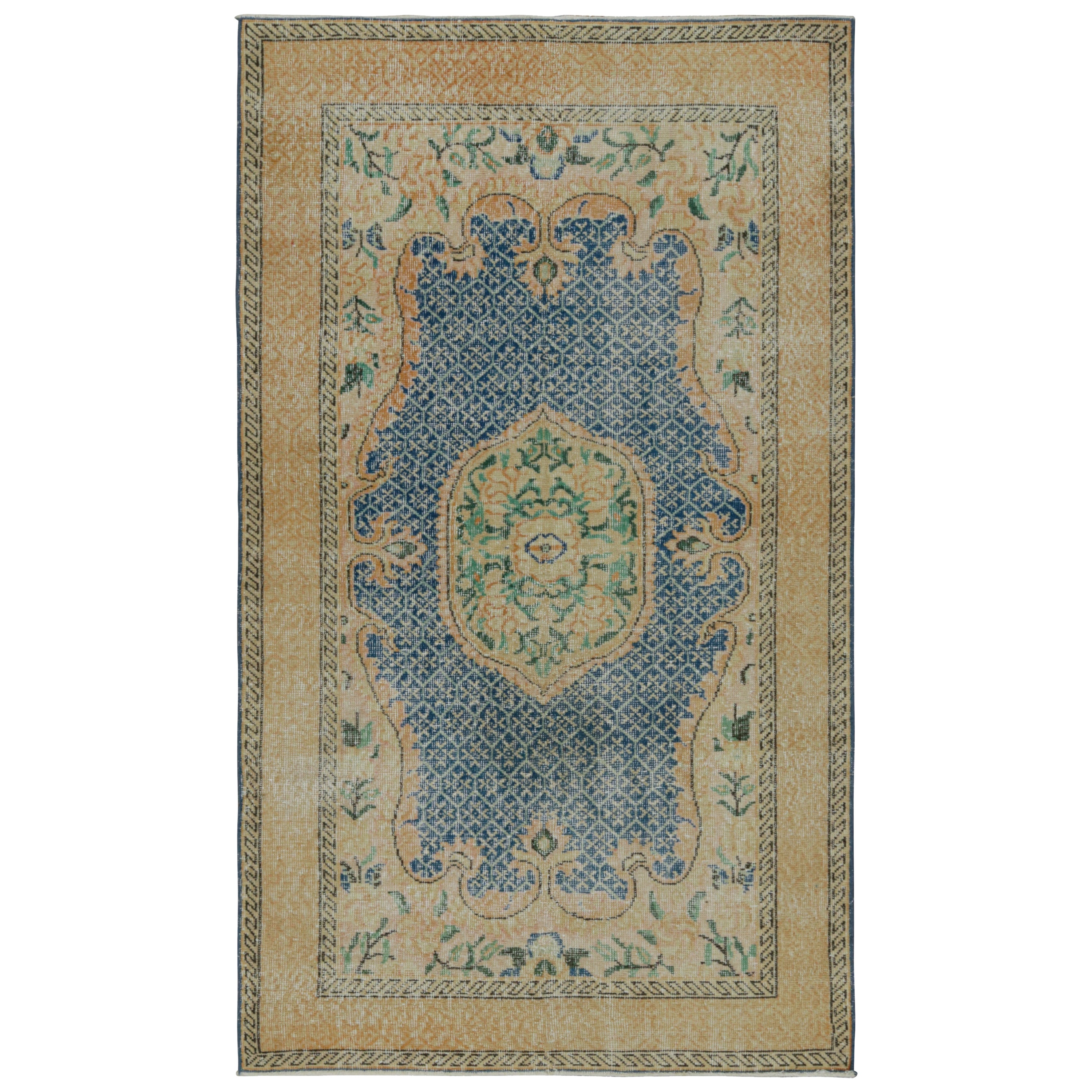 Vintage Turkish Rug with Gold Medallion and Blue Open field, from Rug & Kilim For Sale