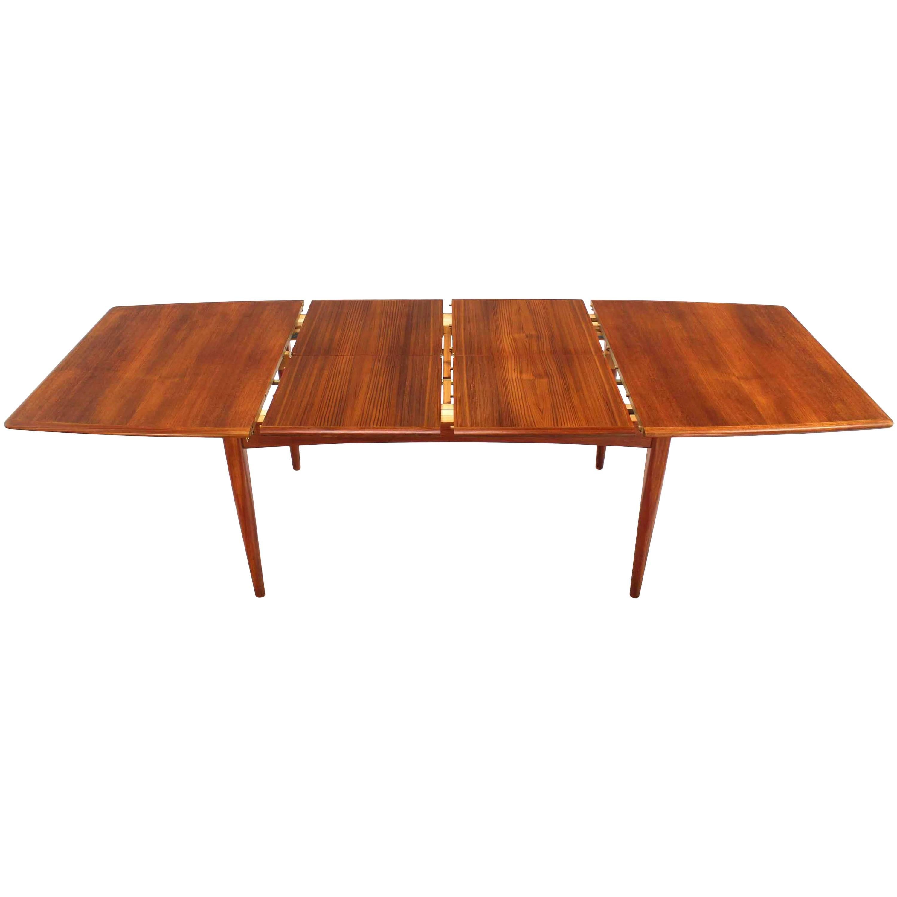 Danish Modern Teak Boat Shape Dining Table with Two Pop-Up Leafs Extension Board For Sale