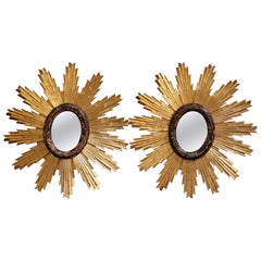 Paire de miroirs muraux Sunburst italiens sculptés en bois doré bicolore et noirci