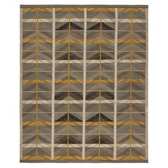 Rug & Kilim's Teppich im skandinavischen Stil mit braunen, blauen und goldenen Mustern