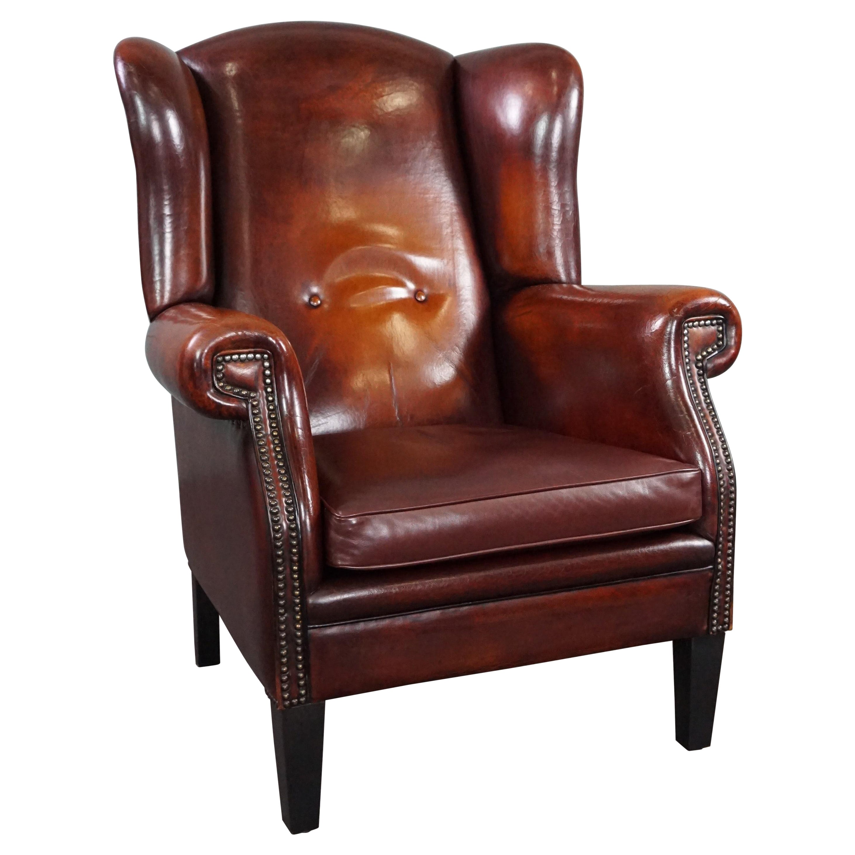 Beautiful patinated sheepskin leather armchair For Sale
