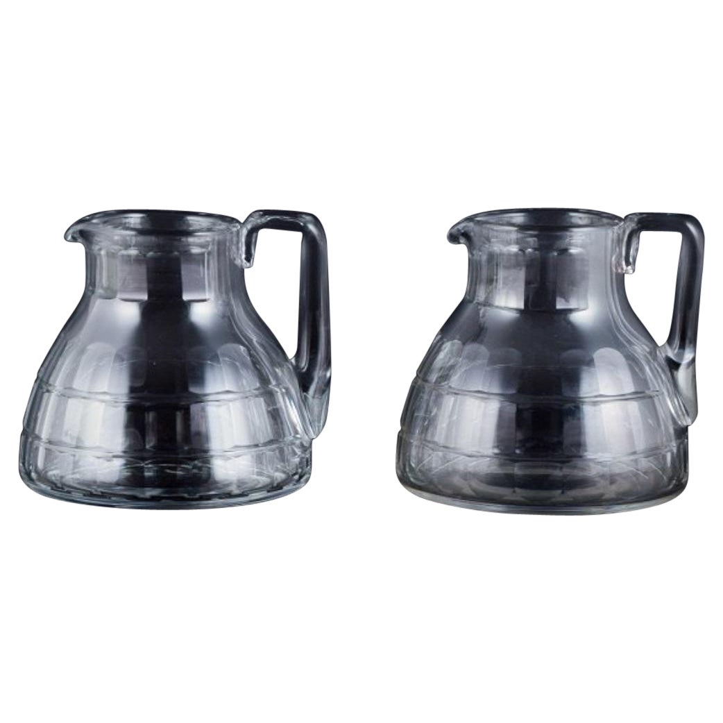 Baccarat, France, two "Charmes" Art Deco pitchers in clear crystal glass. For Sale