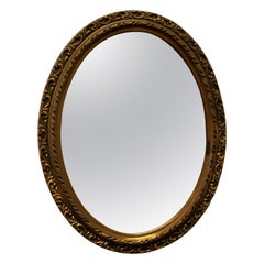 Pretty Gilt Oval Mirror  This Mirror has a 2” wide deeply moulded oval frame, th