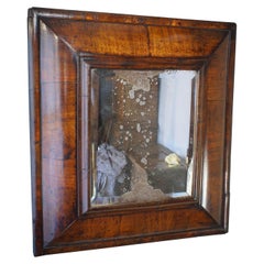 A 17th Century William And Mary Walnut Cushion Moulded Mirror.