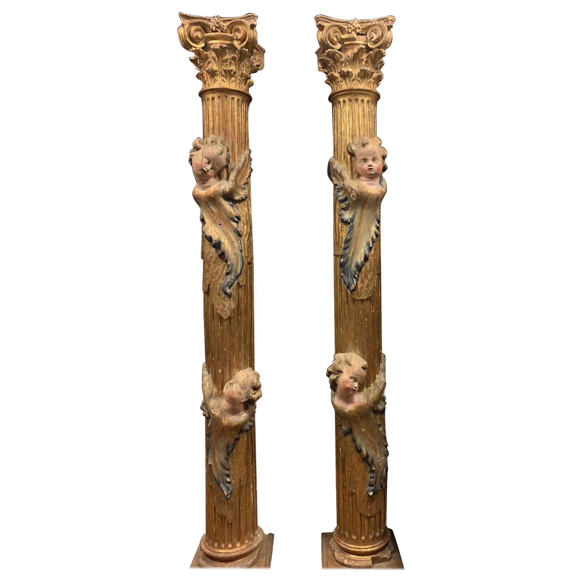Pair of wooden columns, carved and gilded with polychrome putti, from Spain For Sale
