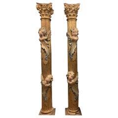 Pair of wooden columns, carved and gilded with polychrome putti, from Spain