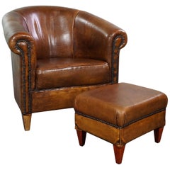 Set of a sheepskin club armchair and matching ottoman