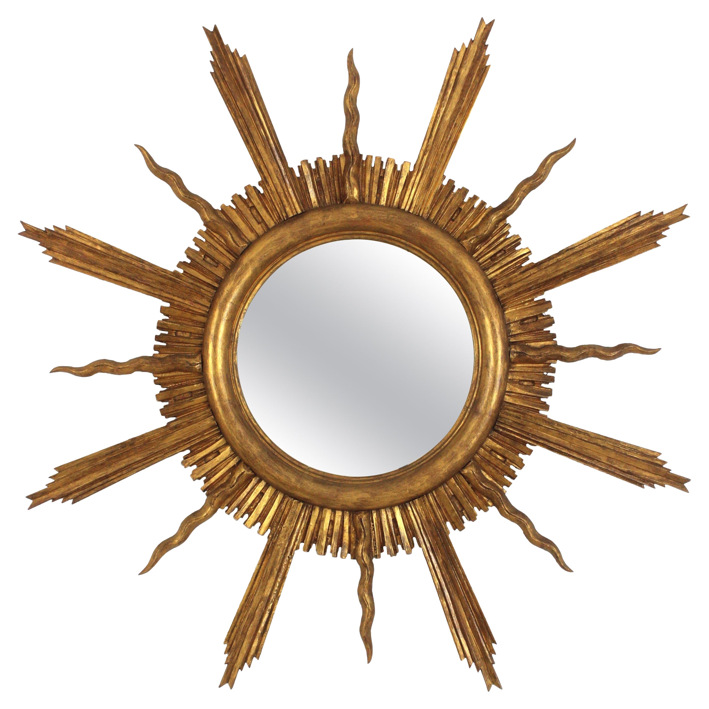 Grand miroir en bois doré étoilé dans le style de Gilbert Poillerat