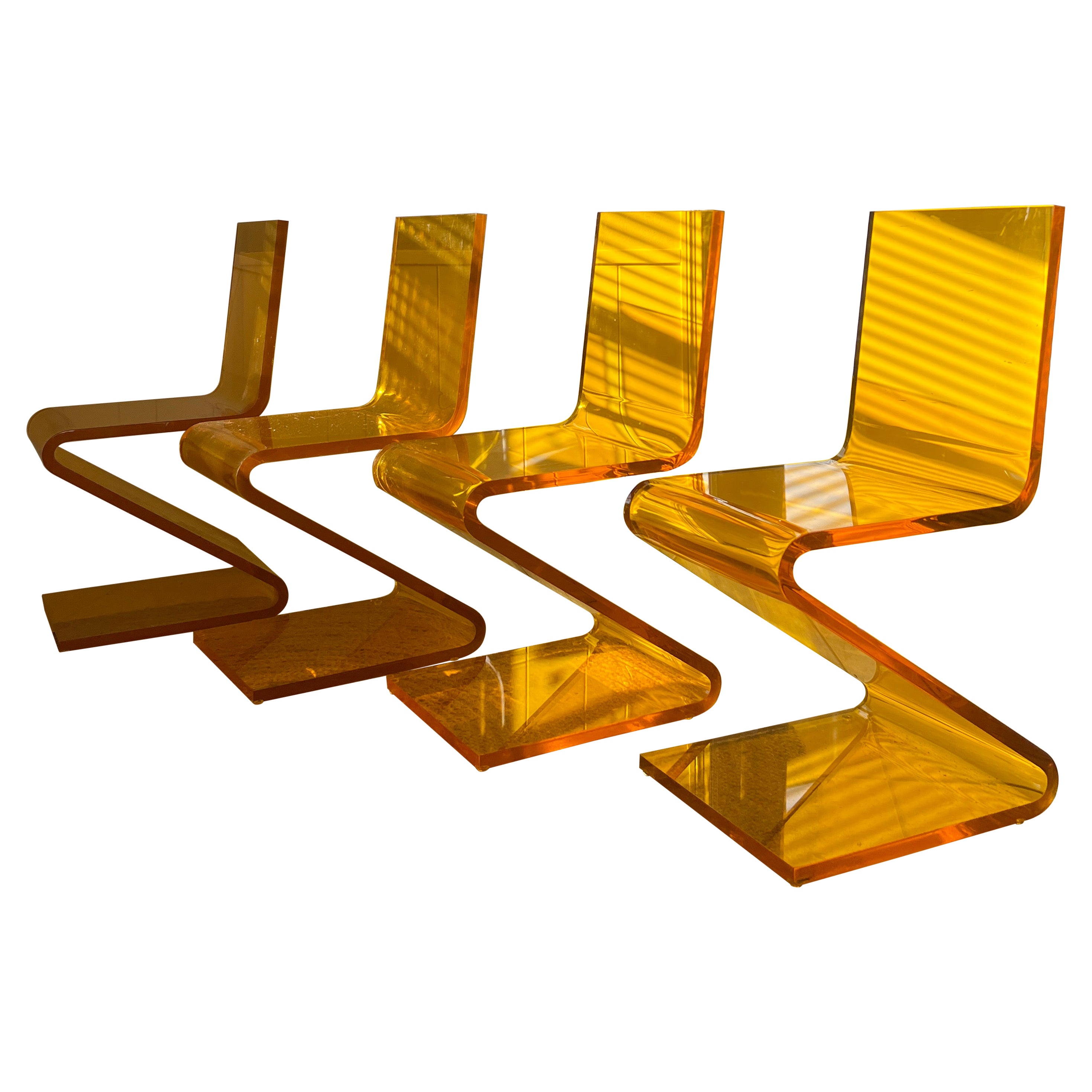 A set of four Z chairs by Haziza in a 1” thick lucite orange color For Sale