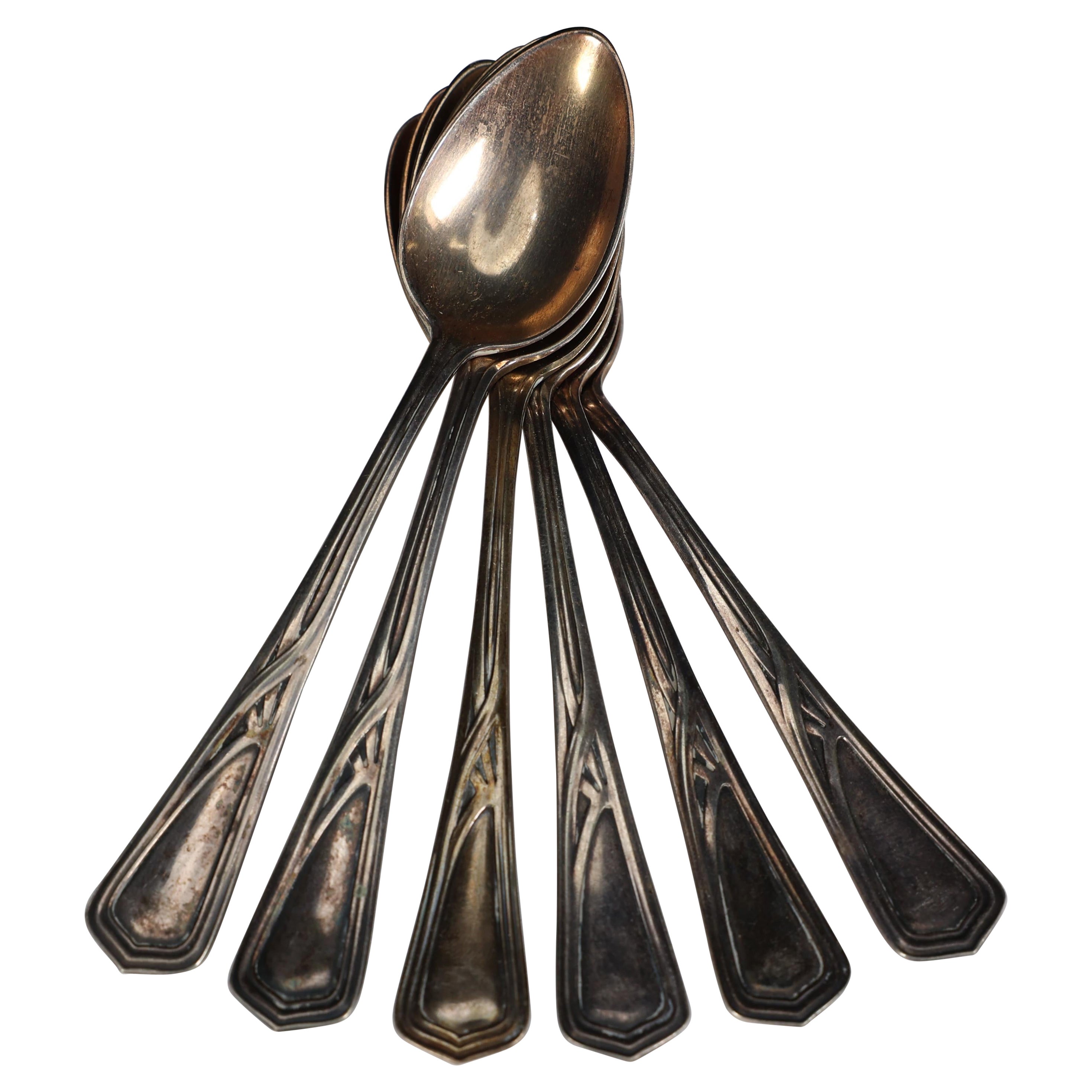 WMF. A set of six Art Nouveau silver plated desert spoons in unused condition.