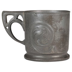 Liberty and Co. An Arts and Crafts pewter Christening mug