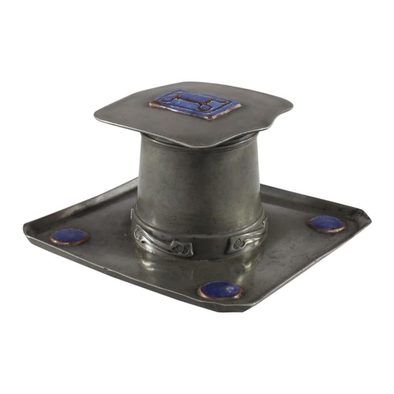 Liberty & Co. An Arts & Crafts Pewter Inkwell with Violet Enamel Decoration.