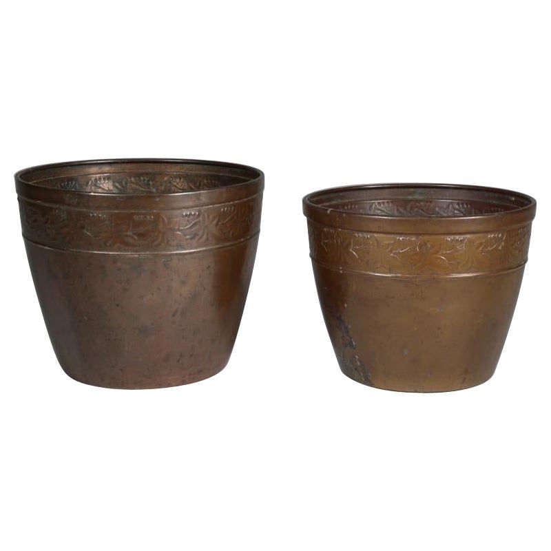 J S & Sons. A pair of Arts and Crafts copper planter with floral decoration For Sale