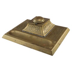 Antique Margaret Gilmour School. An Arts & Crafts brass inkwell with Celtic interlacing.
