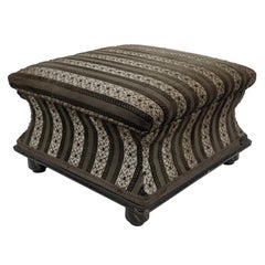 An Aesthetic Movement ebonized & gilded foot stool with striped upholstery.